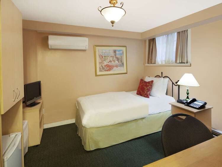 Guest room with one single bed beside a nightstand