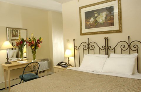 A room with a king bed and a desk