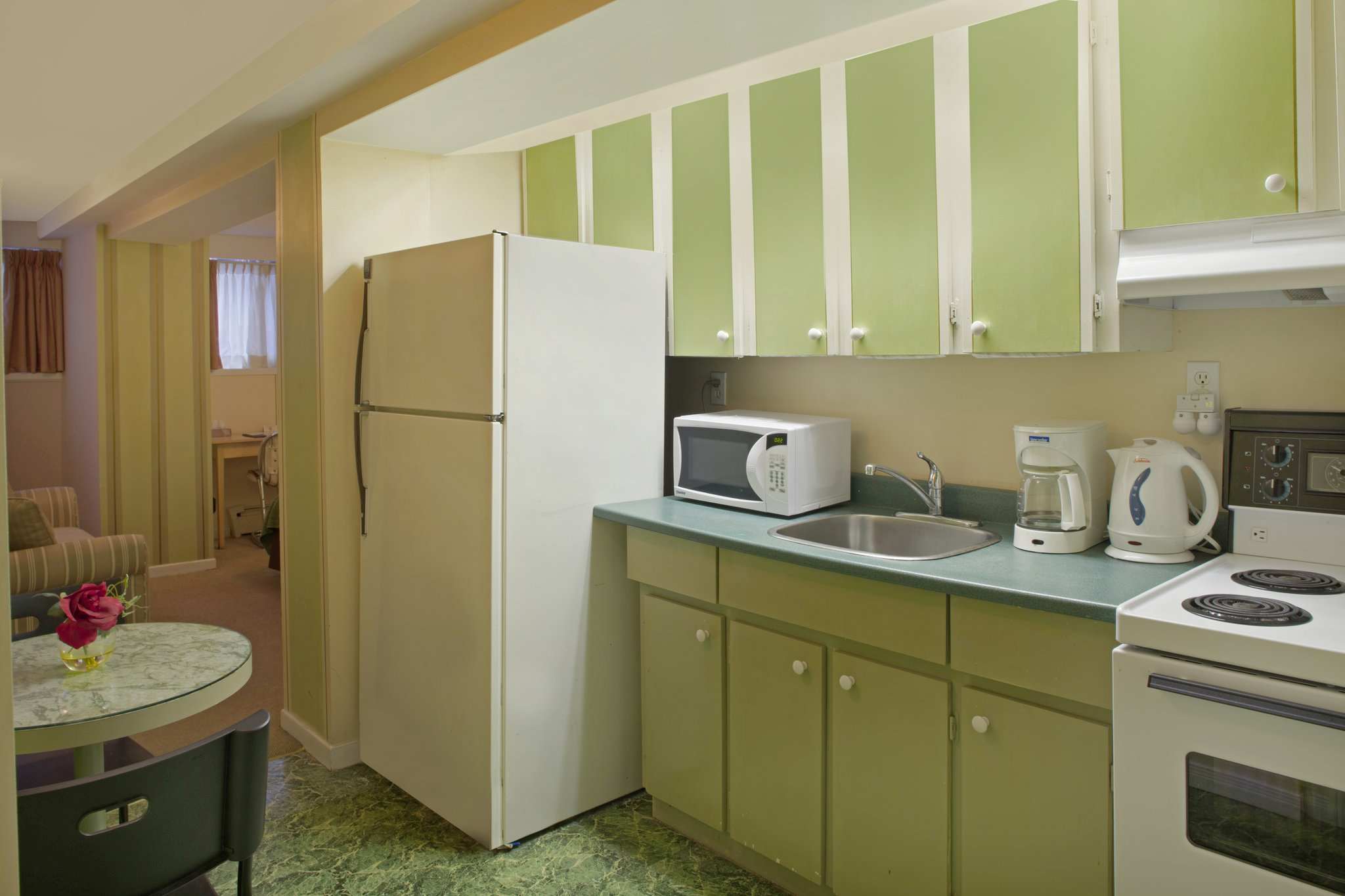 A fully-equipped kitchen with a fridge, a microwave, and a stove